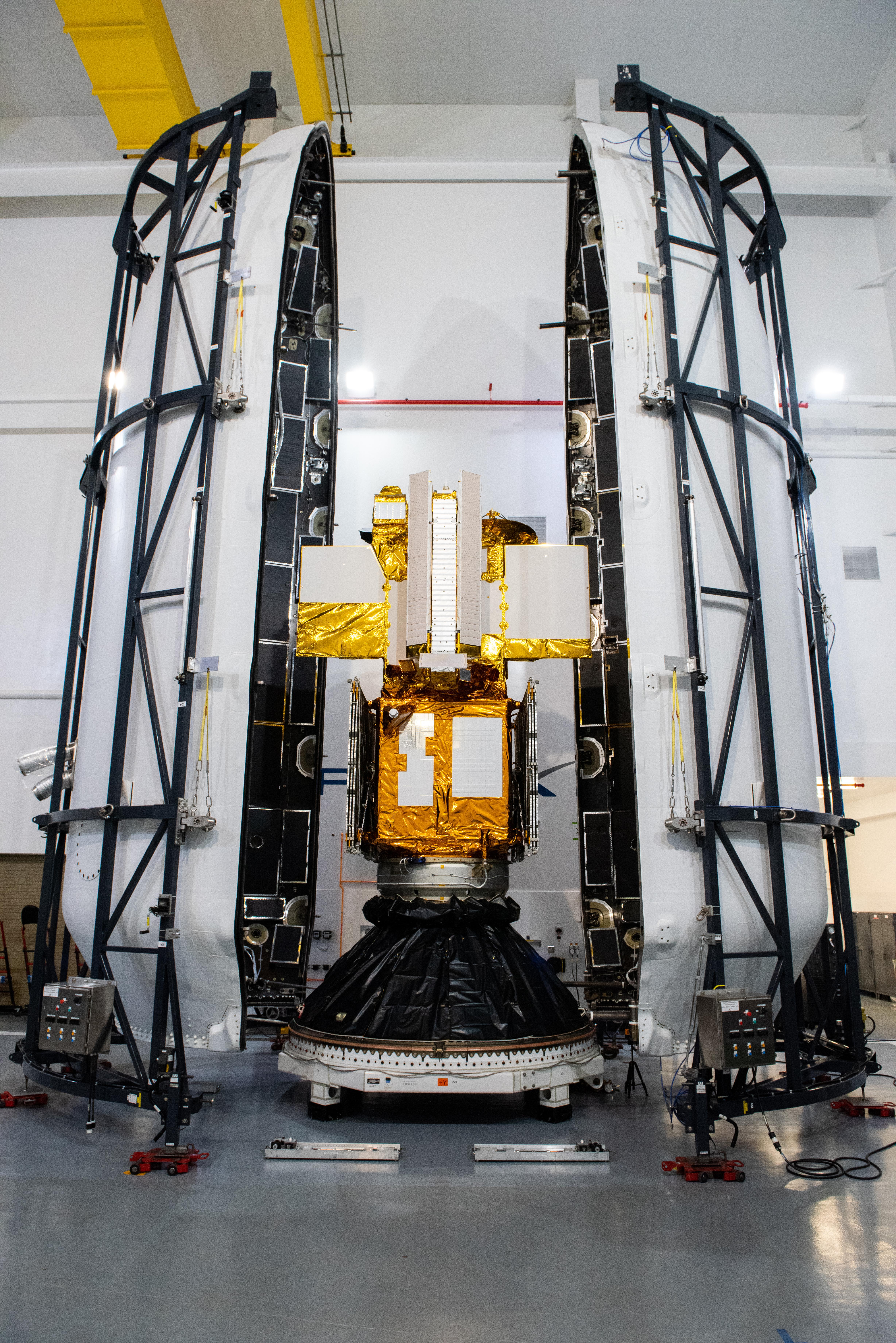 A photo of the SWOT satellite being encapsulated in its payload fairing.